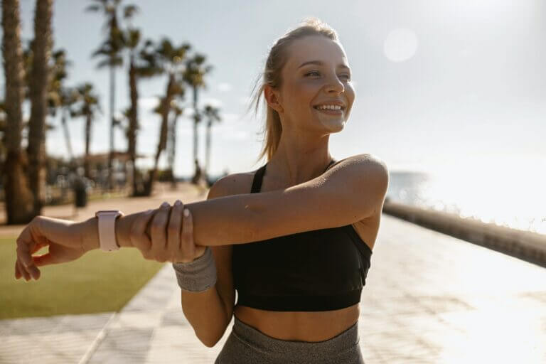 Beautiful athletic woman relaxing outdoors in morning