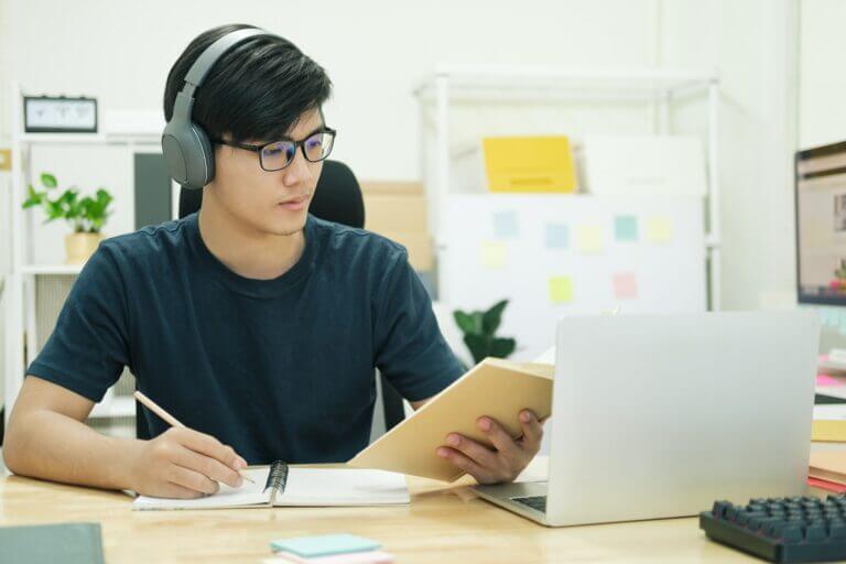 Young man study in front of the laptop computer at home